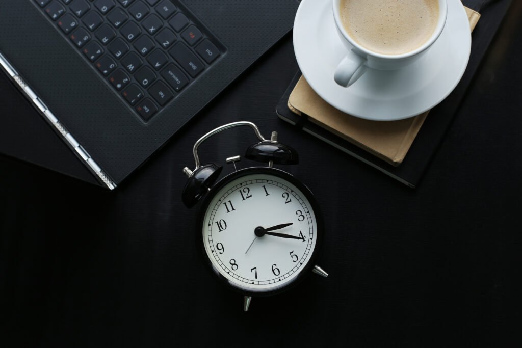 A busy table with a clock refers to automate your work and save time